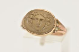 A 9CT GOLD LAVA CAMEO RING, oval cameo depicting the face of Medusa, collet set to the trifurcated