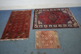 A RED WOOLEN RUG, with twelve medallions, and a multi-strap border, a larger woollen rug with