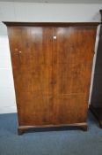 AN EARLY 20TH CENTURY WALNUT DOUBLE DOOR WARDROBE, raised on bracket feet, width 130cm x depth
