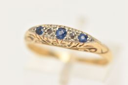A YELLOW METAL SAPPHIRE AND DIAMOND RING, set with three circular cut blue sapphires, and two rose