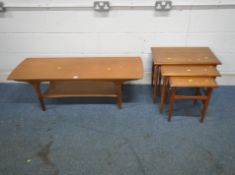 A MID CENTURY TEAK COFFEE TABLE, raised on cylindrical turned legs, united by a bergère