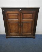 A SLIM OAK PANELLED TWO DOOR CUPBOARD, width 129cm x depth 28cm x height 129cm (condition report: