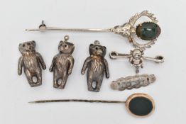 A SMALL BAG OF JEWELLERY, to include three silver teddy bear charms, each hallmarked Birmingham, a