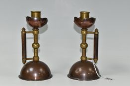A PAIR OF LATE NINETEENTH CENTURY CANDLESTICKS AFTER A DESIGN BY CHRISTOPHER DRESSER, for Benham &