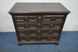 A 19TH CENTURY OAK CHEST OF FOUR LONG DRAWERS, the drawer fronts with geometric designs, raised on