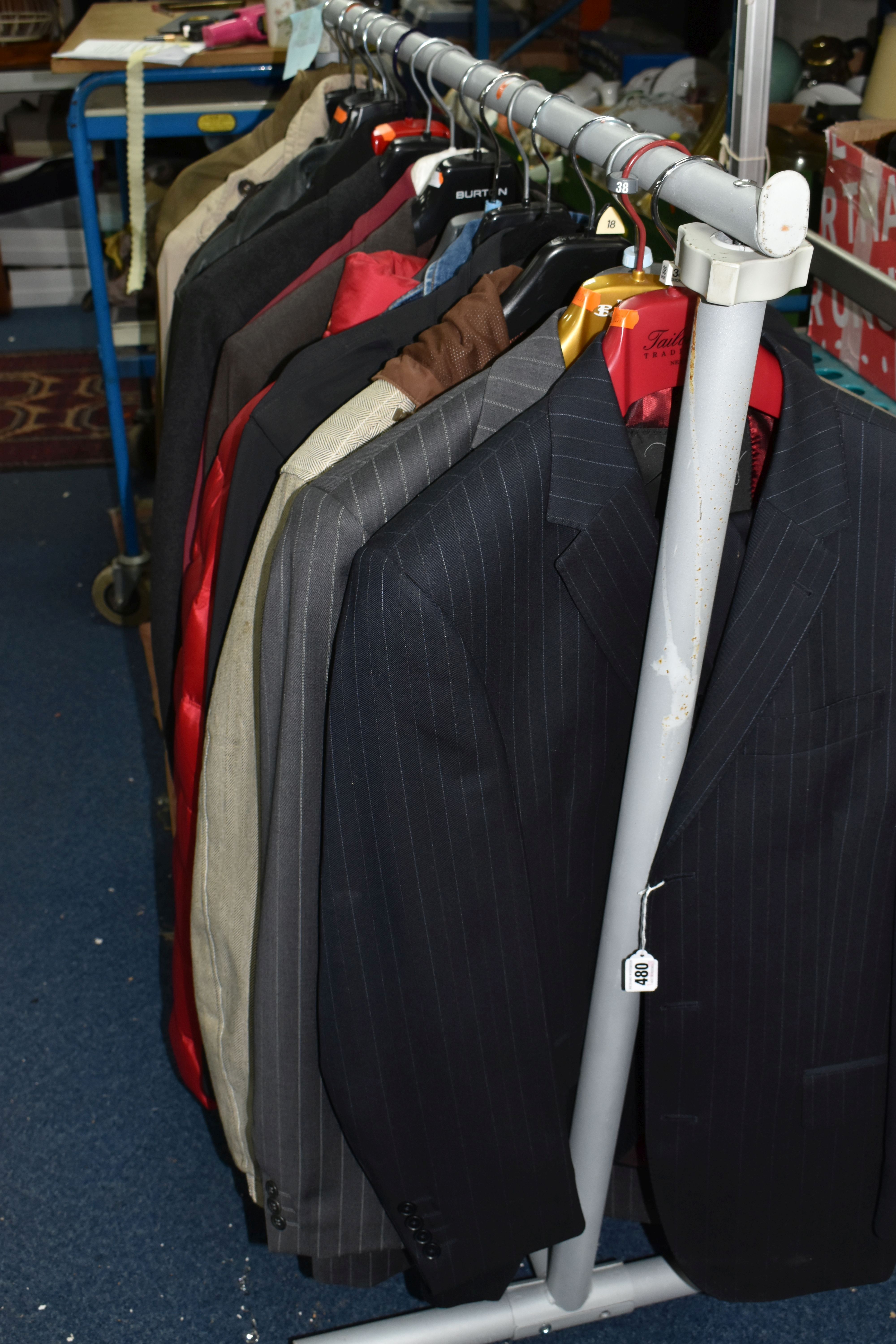 A SMALL CLOTHES RAIL AND A GROUP OF GENTLEMEN'S DESIGNER JACKETS AND SUITS, comprising a black