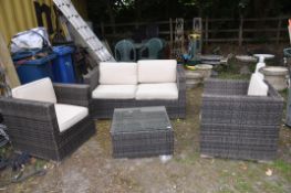 A RATTAN EFFECT GARDEN SUITE consisting of a 144cm wide sofa, two arm chairs and a square centre