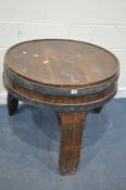 AN OAK AND METAL BANDED BARREL PUB TABLE, raised on three legs, united by stretchers, diameter