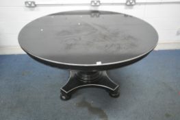 A LARGE EBONISED CIRCULAR DINING TABLE, on a cylindrical pillar, shaped base on bun feet, diameter