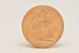 A FULL GOLD SOVEREIGN COIN, obverse depicting George V, reverse with George and the Dragon, dated