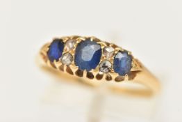 A YELLOW METAL GEM SET RING, set with three oval cut blue sapphires, and four rose cut diamonds,