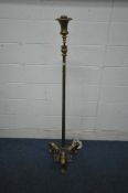 A BRASS STANDARD LAMP, with a shaped top, a Corinthian style support, raised on three flamboyant