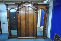 AN EDWARDIAN MAHOANY COMPACTUM WARDROBE, the central double doors enclosing a five linen slides,