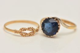 TWO YELLOW METAL RINGS, the first set with a circular cut blue paste, claw setting to cross over