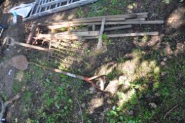 A COLECTION OF MOSTLY VINTAGE GARDEN TOOLS including hay forks, rakes, an past shovel, lawn