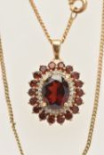 A 9CT GOLD GEM SET NECKLACE, an oval cut garnet prong set with a surround of diamonds and garnets,