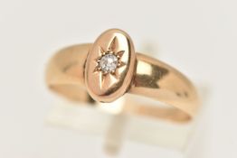 A YELLOW METAL RING, an oval yellow metal mount set with a single old cut diamond, fitted with a
