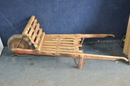 A VINTAGE RAILWAY PORTERS LUGGAGE TRUCK constructed from pine slats over an oak frame with a later