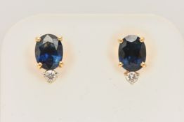 A PAIR OF YELLOW METAL SAPPHIRE AND DIAMOND EARRINGS, each earring set with an oval cut blue