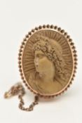 A LAVA CAMEO BROOCH, of oval outline, depicting in high relief a lady in profile, with twist