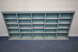A LARGE TEAL SHELVING UNIT, with an arrangement of shelving, length 305cm x depth 27cm x height