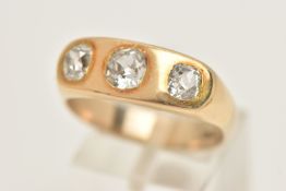A YELLOW METAL THREE STONE DIAMOND RING, three old mine cut diamonds, approximate total diamond