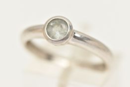A 9CT WHITE GOLD GEM SET RING, designed as a circular aquamarine in a collet setting to the plain