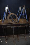 A PAIR OF VICRORIAN CAST IRON TRESTLE STANDS width 77cm height 73cm, a vintage stirrup pump and a