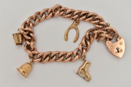 A YELLOW METAL CHARM BRACELET, a hollow curb link bracelet, fitted with a heart padlock clasp,