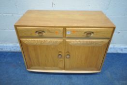 LUCIAN ERCOLANI, A MID CENTURY ELM AND BEECH CABINET, fitted with two drawers, above double cupboard