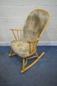 LUCIAN ERCOLANI, A MID CENTURY ELM AND BEECH ROCKING CHAIR, the central splat with swan details,