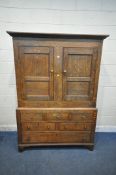 A GEORGIAN OAK WELSH CUPBOARD, fitted with double doors, atop a base with three dummy drawers, above