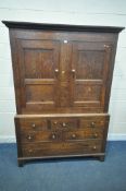A GEORGIAN OAK WELSH CUPBOARD, fitted with double doors, atop a base with three dummy drawers, above