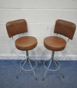 A PAIR OF BROWN LEATHER SWIVEL BAR STOOLS, raised on a cylindrical support and four legs, height