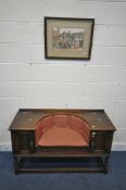 AN OLD CHARM STYLE OAK TELEPHONE SEAT, with a recessed demi-lune seat, flanked by two doors,