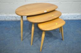LUCIAN ERCOLANI, A MID CENTURY ELM AND BEECH PEBBLE NEST OF THREE TABLES, raised on cylindrical