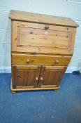 A MODERN PINE BUREAU, the fall front door enclosing a fitted interior, above a single drawer and