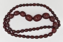 A CHERRY BAKELITE BEAD NECKLACE, a single row of oval graduating beads, largest measuring 22.2mm x