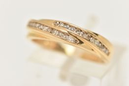 AN 18CT YELLOW GOLD DIAMOND BAND RING, the ring is of cross over design set with a total of