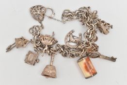 A WHITE METAL CHARM BRACELET, multi link white metal bracelet, fitted with an open work heart