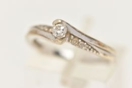 A 9CT WHITE GOLD DIAMOND RING, set with a principal round brilliant cut diamond, measuring