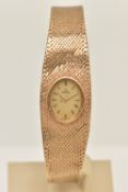 A LADY'S OMEGA 9CT GOLD WRISTWATCH, the oval gold coloured face with baton markers to the mesh