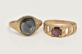 TWO 9CT GOLD RINGS, the first a yellow gold oval signet set with hematite with a carved Centurian
