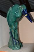 LARGE CERAMIC HERON, pottery study of a heron in a natural setting of reeds, in stooped pose
