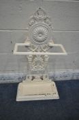 A CREAM PAINTED CAST IRON STICK STAND, with scrolled and foliate details, and a removable drip tray,