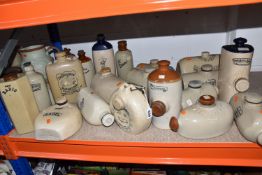 A LARGE QUANTITY OF STONEWARE FOOT WARMERS, comprising twenty assorted foot warmers, maker's names