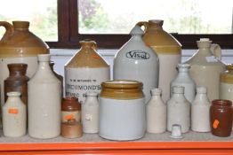 A GROUP OF STONEWARE BREWERIANA comprising assorted printed and plain bottles of varying sizes to