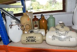A GROUP OF ELEVEN STONEWARE FOOT WARMERS, comprising two Doulton -Lambeth, a D.B.C and a Philpott'