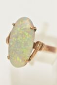AN OPAL RING, designed as an oval opal cabochon in a four claw setting to the twist design shoulders