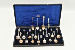A SELECTION OF EIGHTEEN SOUVENIR TEASPOONS AND A SILVER BOOKMARK, to include a blue enamel Marius